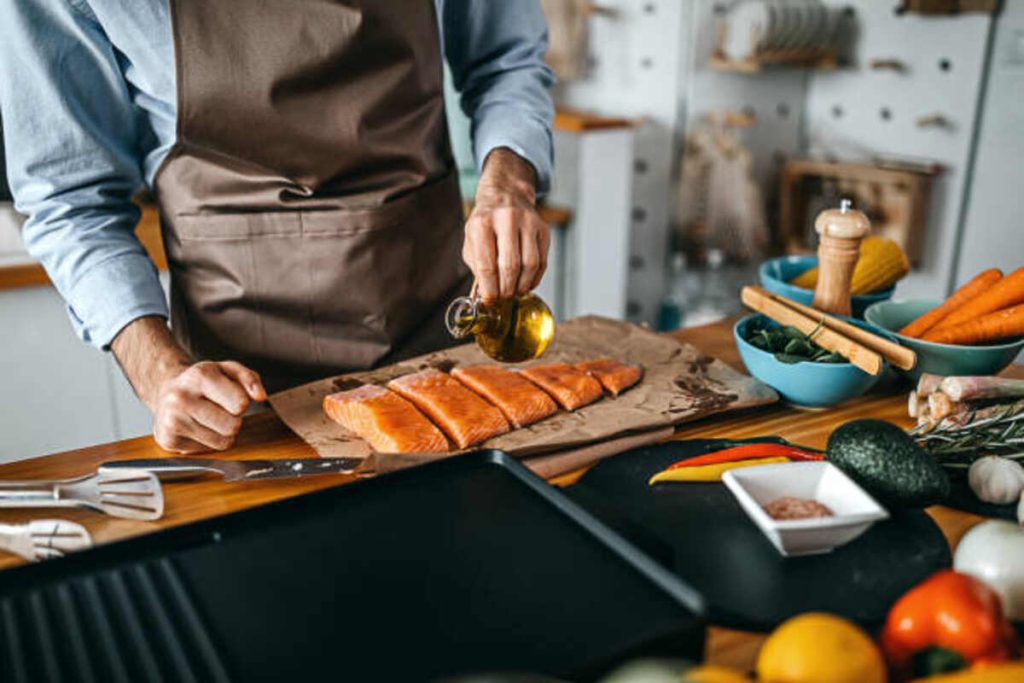 Food Worker Prepares a Fish Fillet For Cooking