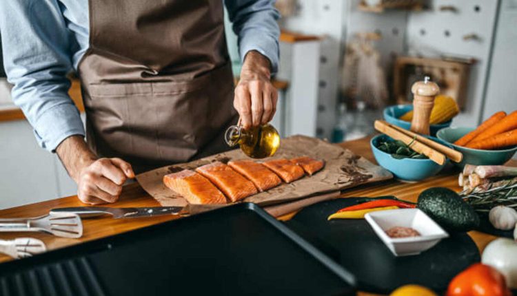 Food Worker Prepares a Fish Fillet For Cooking
